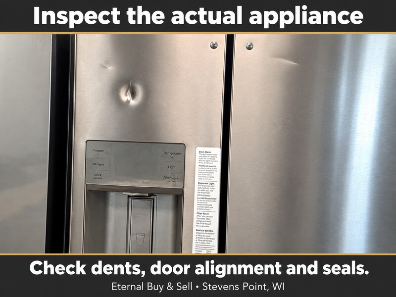 Close view of a visible dent on a refrigerator door above its dispenser